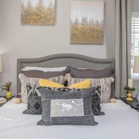 a bed with pillows and lamps