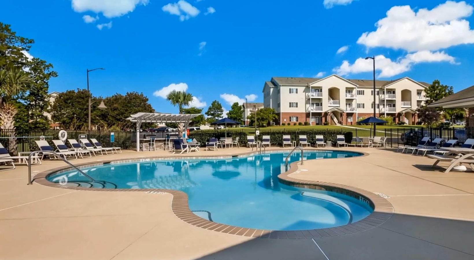 a swimming pool with lounge chairs
