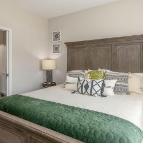 a bed with a green headboard