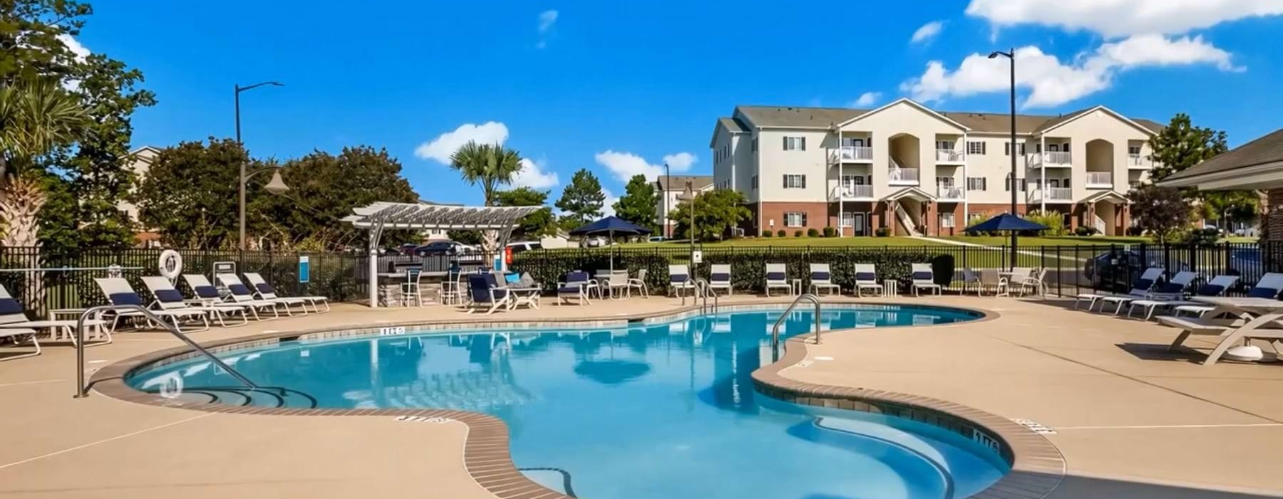 a swimming pool with lounge chairs